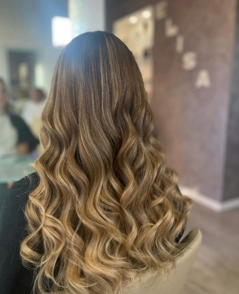Capelli lunghi con balayage miele e onde a cascata